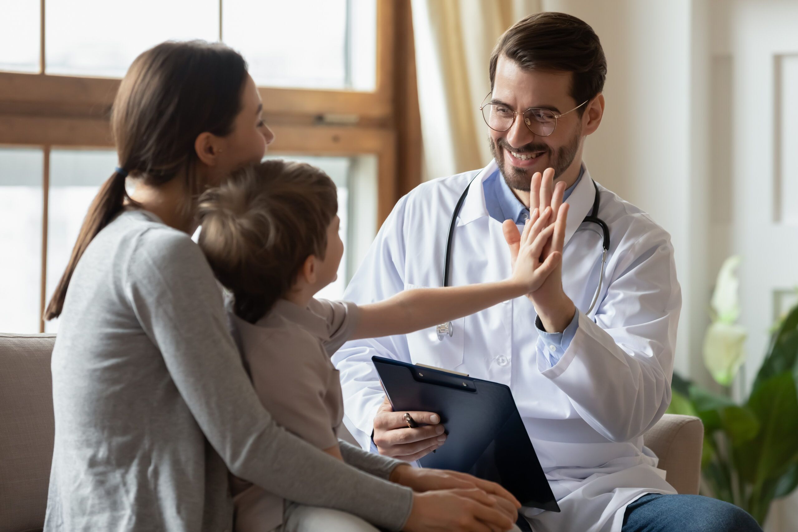 NORD photo: Male doctor cheering boy.